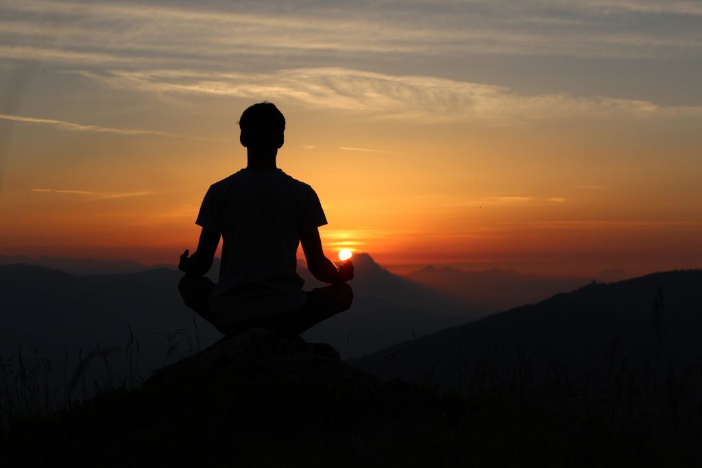 Man meditating outdoors